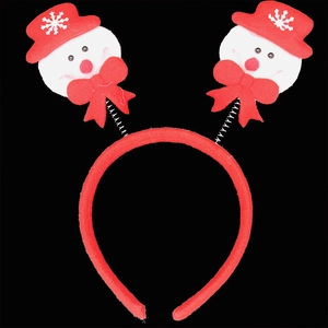 Close-up of red Christmas headband with cute snowman on springs against black background