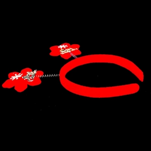 Detail of red Christmas headband with spring-loaded Merry Christmas flower sequins