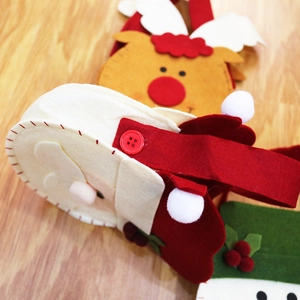 Close-up of handmade felt Christmas gift bags with Santa and Reindeer sewing details
