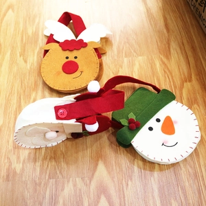 Detailed view of handmade felt Christmas gift bags with reindeer and snowman patterns