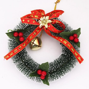 Close-up of 15cm mini Christmas wreath with snowy pine needles and a red bow decoration