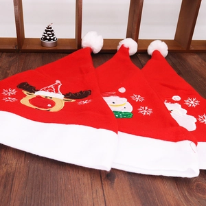 Close-up of red felt Christmas hats featuring embroidered Santa, snowman, and reindeer motifs