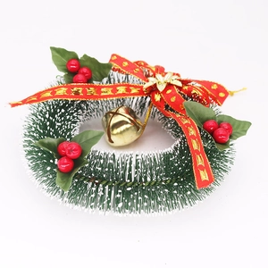 Detail of 15cm Christmas wreath with red berries, golden bell, and pine needles