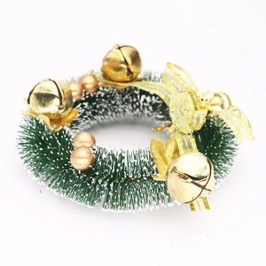 Close-up of 15cm Christmas wreath with gold bells, bow, and snow-tipped pine needles