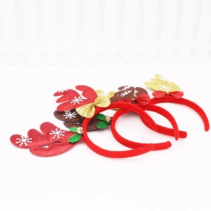 Close-up of glittery reindeer antlers headbands with bells and bows for Christmas