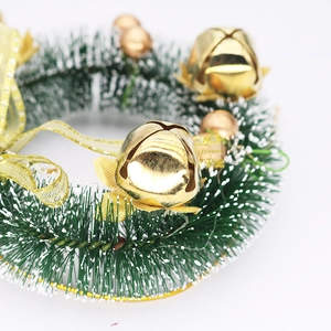Detail of 15cm mini Christmas wreath with snow-tipped pine needles and golden bells