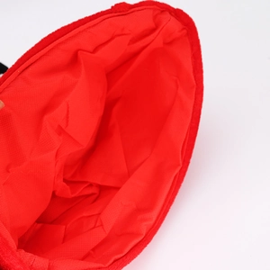 Close-up of red plush fabric lining and durable interior material of Christmas hat