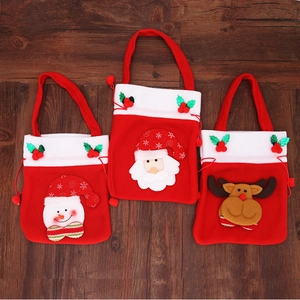 Set of three red festive Christmas gift bags with Santa, snowman and reindeer designs