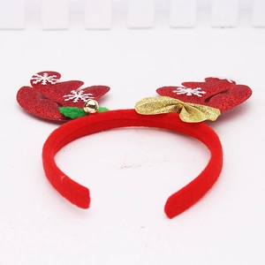 Close-up of red Christmas reindeer antler headband with glitter, gold bow and bell