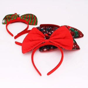 Detail view of various Christmas bow headbands with festive red and green plaid patterns