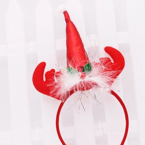 Serre-tête de Noël avec bois de renne rouges, bonnet de Père Noël et décor en plumes
