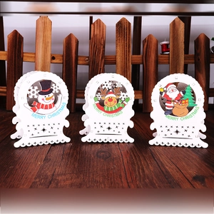 Three-piece set of wooden Christmas table ornaments with white LED lights and festive patterns