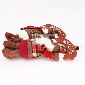 Detail of plush Christmas hanging ornaments with Welcome sign and festive fabric textures