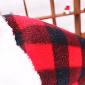 Macro detail of red and black buffalo plaid fabric with soft white fleece lining texture
