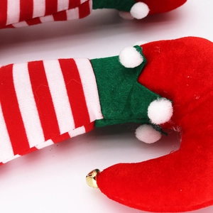 Funny Christmas elf legs hat with green plaid patterns and golden bells on red shoes