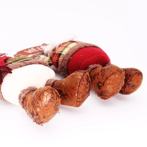 Detail of Christmas plush dolls showing plaid fabric textures and Welcome wooden sign