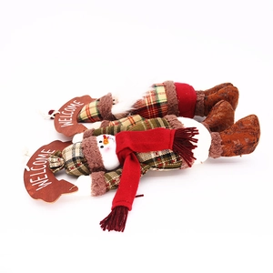 Detail of plush Santa and Snowman hanging decorations with Welcome wooden plaques