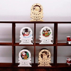 Close-up of wooden Christmas LED house ornaments with Santa Claus and reindeer designs