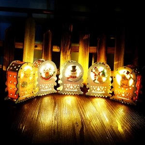 Close-up of wooden Christmas lanterns with LED warm light and laser-cut festive patterns