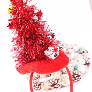 Close-up of red tinsel Christmas tree headband with LED battery box and stars