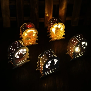 Close-up of warm LED lights glowing through laser-cut wooden Christmas star lanterns
