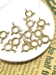 Detailed view of bulk golden alloy spike ring pendants for DIY jewelry making