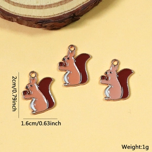 Detail of alloy squirrel charms with acorns and gold edges for DIY jewelry making