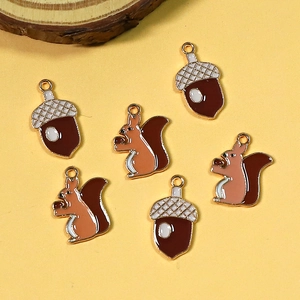 DIY jewelry charms featuring cute enamel squirrels and acorns with golden edges