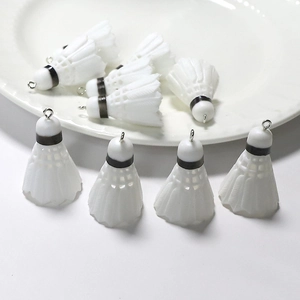 Macro shot of white miniature shuttlecock DIY charms with realistic feather texture