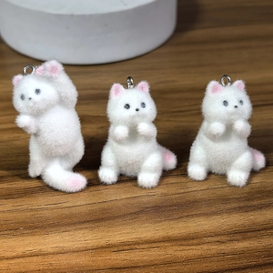 Three white flocked cat pendants for DIY jewelry with pink paws and metal hooks