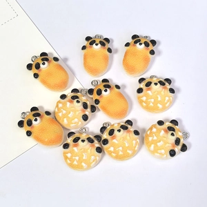 Macro detail of resin panda-shaped faux food charms showing textured realistic surface