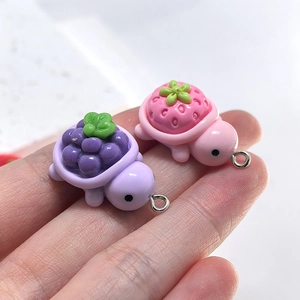 Macro shot of resin fruit turtle pendants with grape and strawberry shell textures