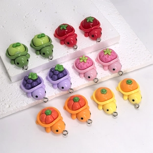 Detail of assorted resin fruit turtles with metal hooks for DIY jewelry making