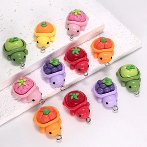 Detail of colorful resin fruit turtle pendants with metal loops for DIY jewelry making