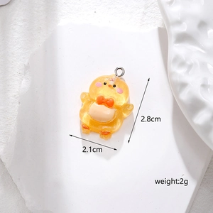 Detailed view of yellow resin chick pendant with 2.1cm x 2.8cm size measurements