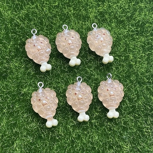 Set of six resin fried chicken drumsticks with cute smiley faces on green grass