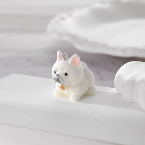 Detail of white flocked French Bulldog charm with pink accents and top metal loop hanger