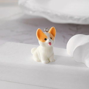 Detailed macro view of a flocked Corgi puppy pendant with a metallic silver split ring