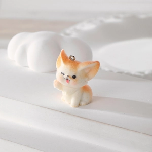 Close-up of cute flocked fox pendant with orange accents and metal loop for DIY jewelry