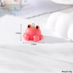 Detailed view of pink resin frog pendant with precise 1.7cm height and 2.3cm width dimensions