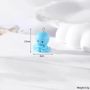 Detail view of a cute blue resin octopus charm with dimensions 2.5cm by 2.0cm