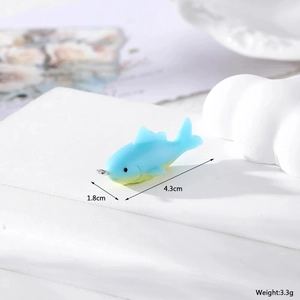Detail view of blue yellow gradient fish pendant with dimensions of 4.3cm by 1.8cm