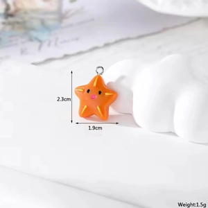 Detail of cute orange resin starfish pendant with smiley face for DIY jewelry making