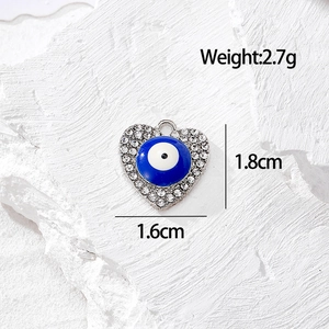 Vista macro del ciondolo a cuore malocchio con strass, misura 1,8cm per 1,6cm