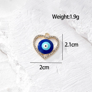 Dettaglio del ciondolo a cuore malocchio dorato da 1,9g con cristalli su fondo pietra