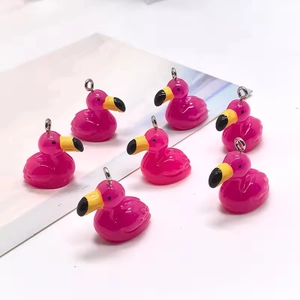 Detailed view of pink resin flamingo charms with silver metal rings for DIY jewelry
