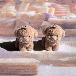 Macro di un ciondolo a forma di cane teddy floccato marrone con texture vellutata