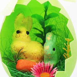 Detail of Easter foam bunnies and carrot inside a green cracked eggshell decoration