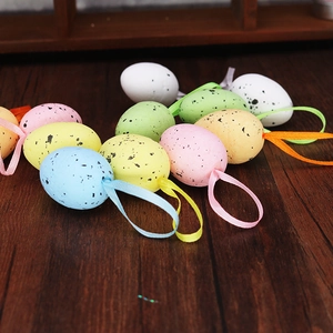 Close-up of colorful Easter egg foam pendants with speckle patterns on wood background