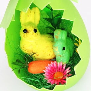Easter foam egg shell with colorful bunny dolls, carrots and flowers for home decoration